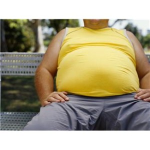 mid section view of a man sitting on a bench in a park --- Image by © Royalty-Free/Corbis