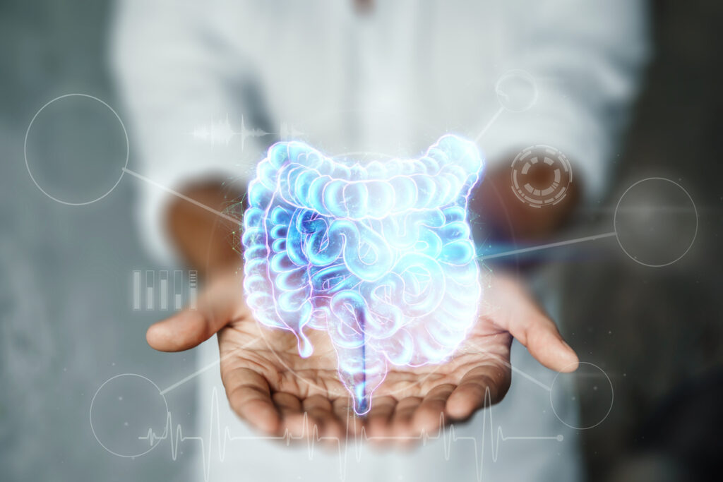 Doctor and holographic bowel scan projection with vital signs and medical records. Concept of new technologies, body scan, digital x-ray, abdominal organs, modern medicine. Doctor and holographic bowel scan projection with vital signs and medical records. Concept of new technologies, body scan, digital x-ray, abdominal organs, modern medicine