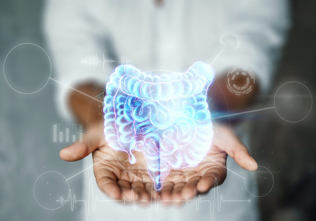Doctor and holographic bowel scan projection with vital signs and medical records. Concept of new technologies, body scan, digital x-ray, abdominal organs, modern medicine. Doctor and holographic bowel scan projection with vital signs and medical records. Concept of new technologies, body scan, digital x-ray, abdominal organs, modern medicine
